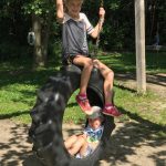 child swings on tractor tire