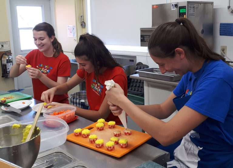 Sunflower Cafe staff decorating cup cakes